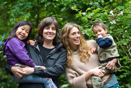 Photo of SPOON founders Cindy and Mishelle each holding their young child.