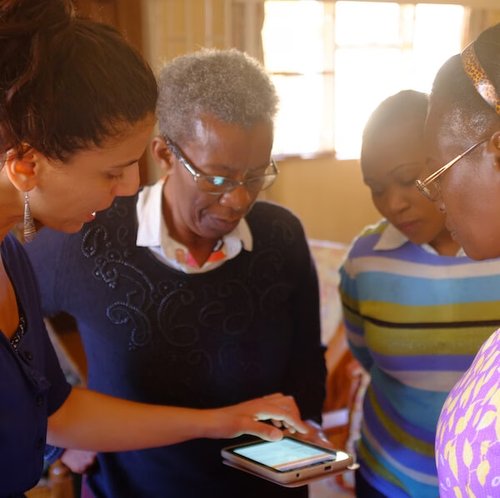Four women looking at a tablet